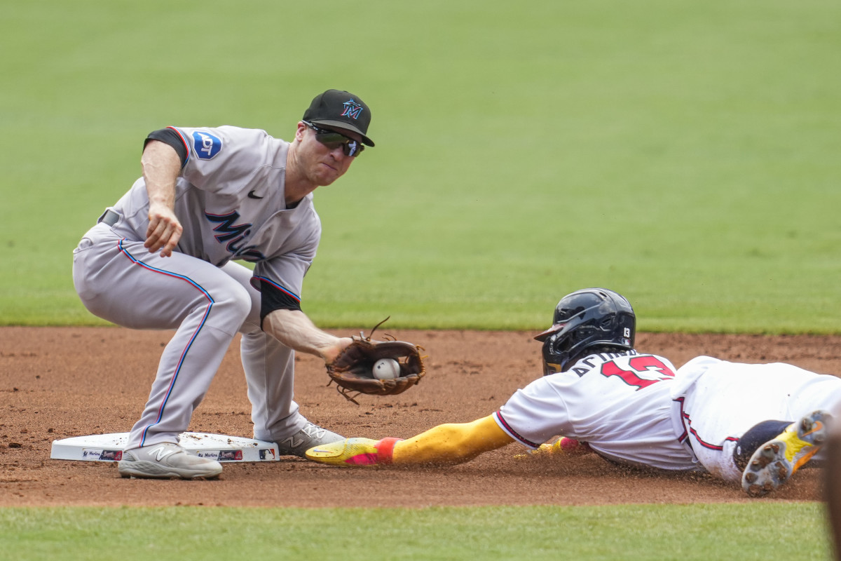 Jul 2, 2023; Cumberland, Georgia, USA; Atlanta Braves right fielder Ronald Acuna Jr. (13) steals second base under Miami Marlins shortstop Joey Wendle (18) during the first inning at Truist Park.